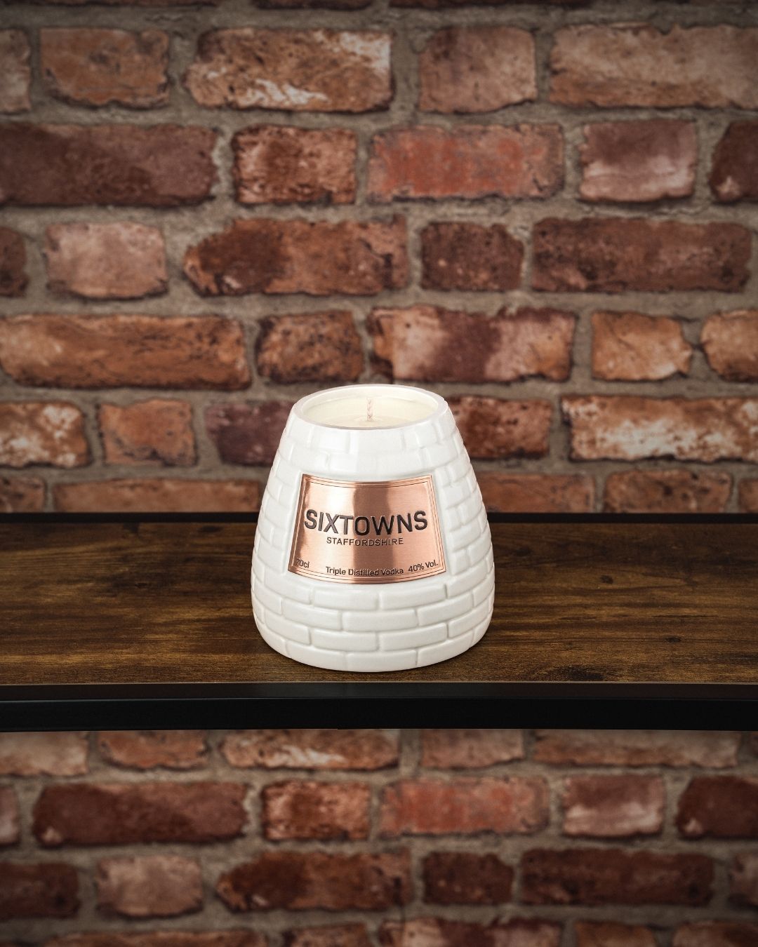 SIXTOWNS scented candle in cream ceramic vodka bottle, hand-poured with original embossed label
